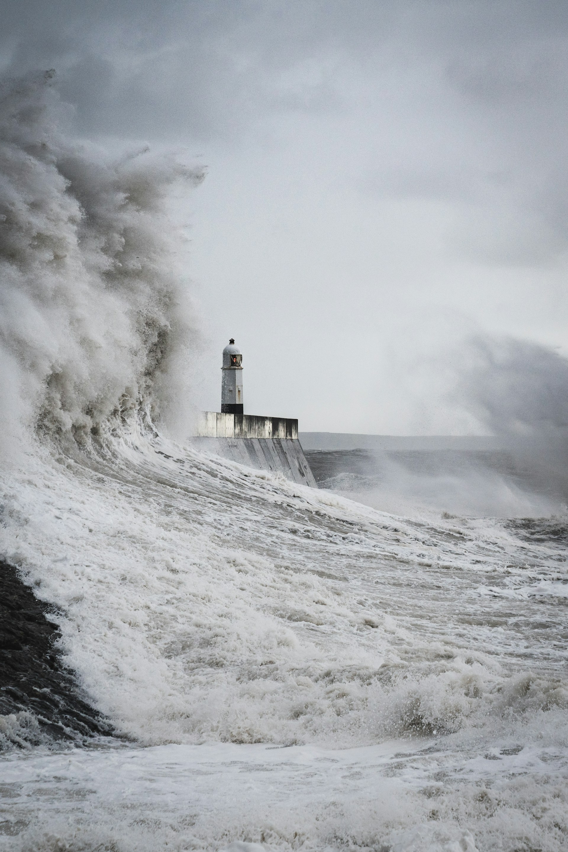 Leuchtturm inmitten einer brechenden Welle